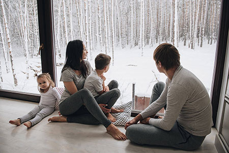 Photo d’une famille dans le confort de leur foyer, en hiver.